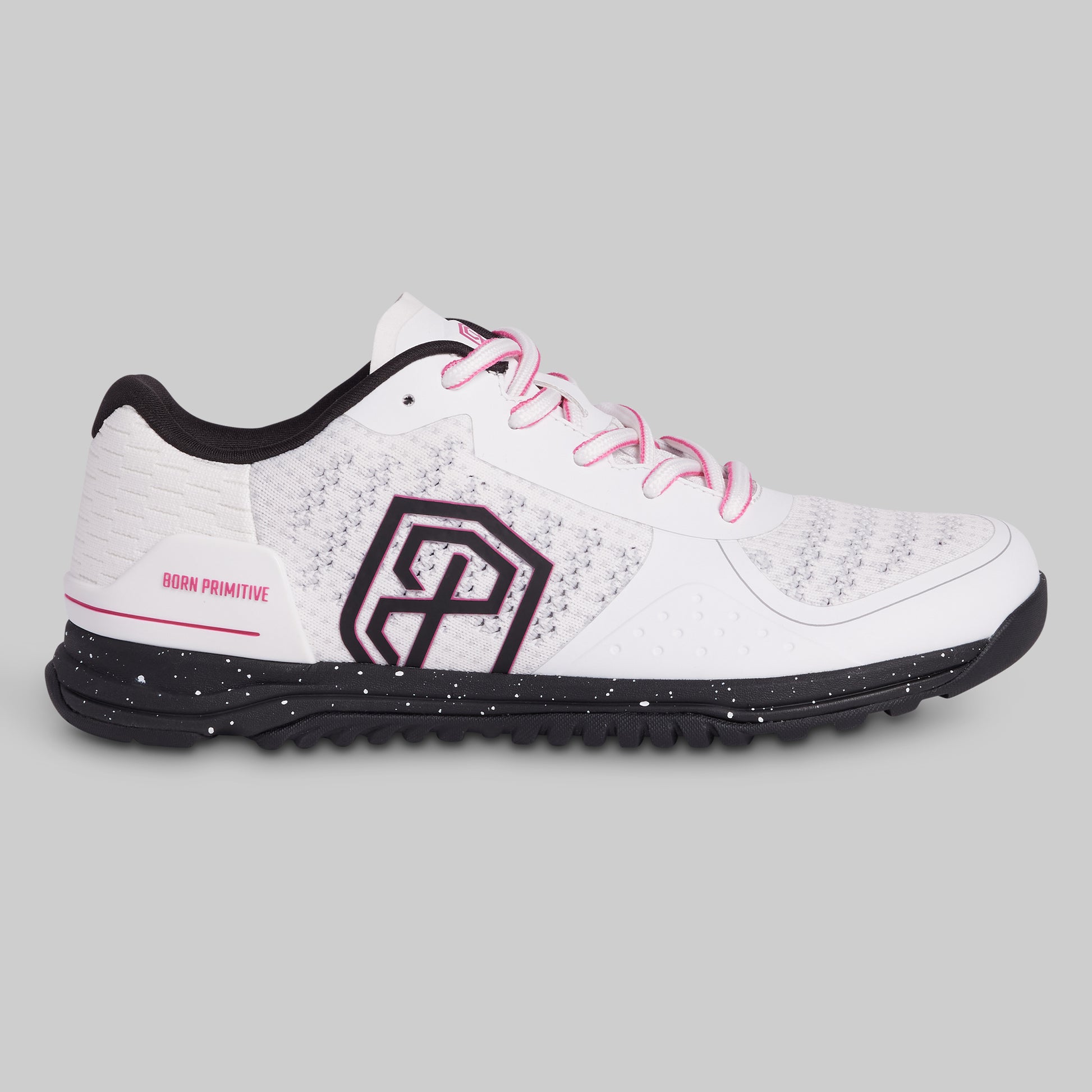 White athletic shoe with black sole and pink laces on a gray background