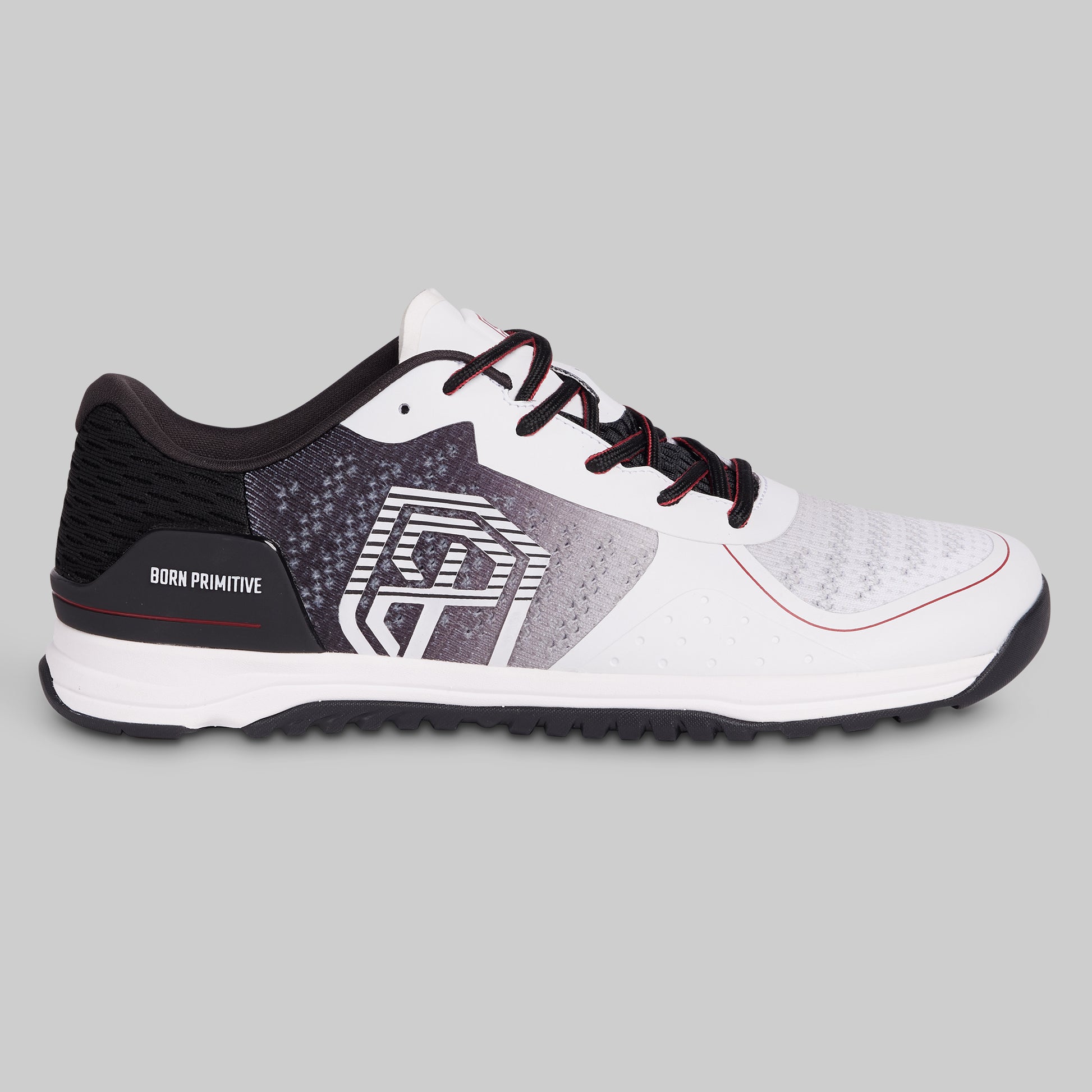 White and black athletic shoe with red accents on a gray background