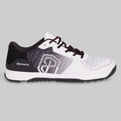 White and black athletic shoe with red accents on a gray background