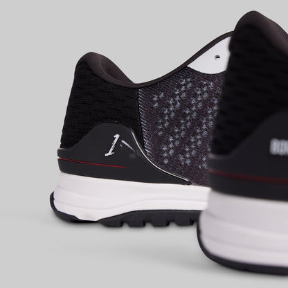 Close-up of black and white athletic shoes on a light gray background