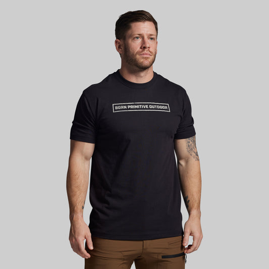 Man wearing a black t-shirt with text on a gray background