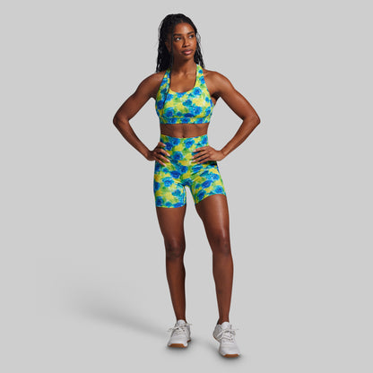 Woman wearing a colorful athletic outfit on a gray background