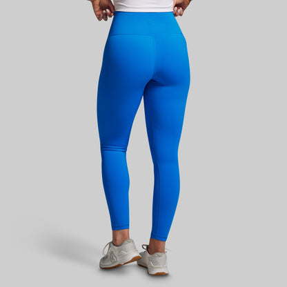 Blue leggings worn by a person on a gray background
