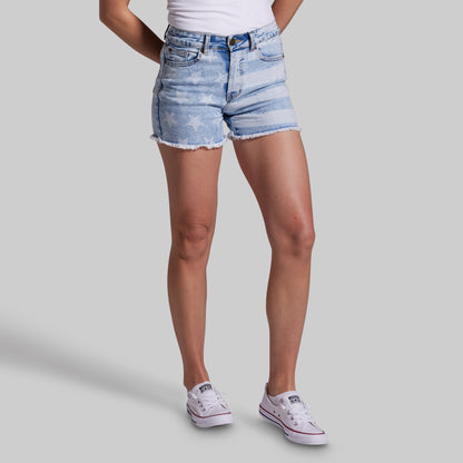 Person wearing light blue denim shorts on a gray background