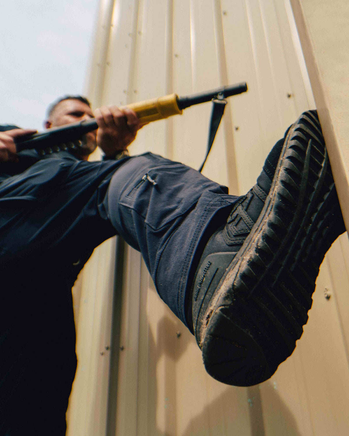 Defender 1 duty boot black being worn while kicking a door 