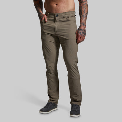 Person wearing brown pants on a plain background