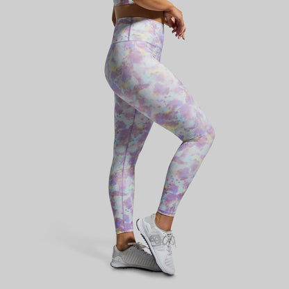 Person wearing colorful leggings on a gray background