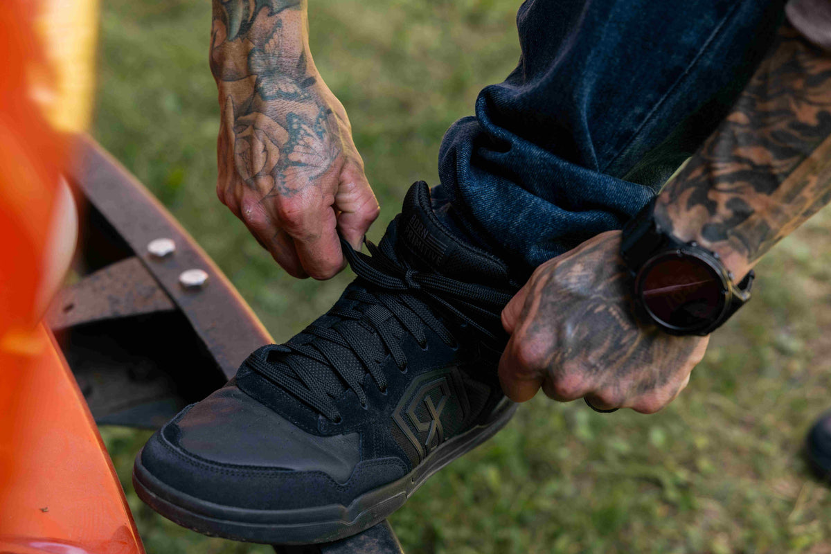 Black Urban Recon 1 shoe being tied 