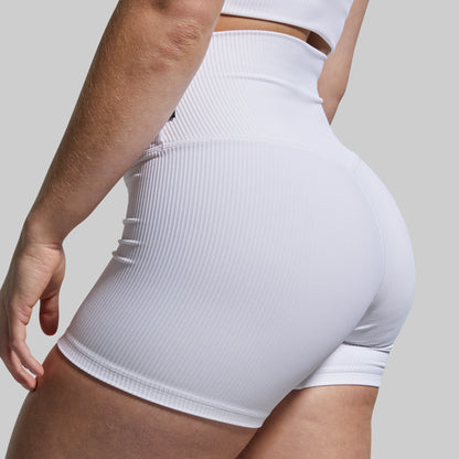 White ribbed high-waisted shorts worn by a person on a light gray background