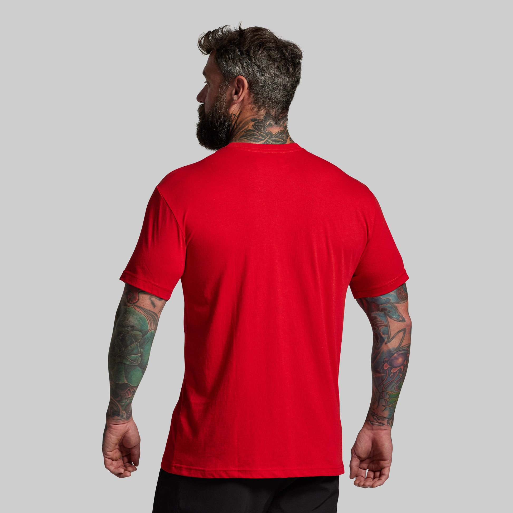 Man wearing a red t-shirt on a gray background