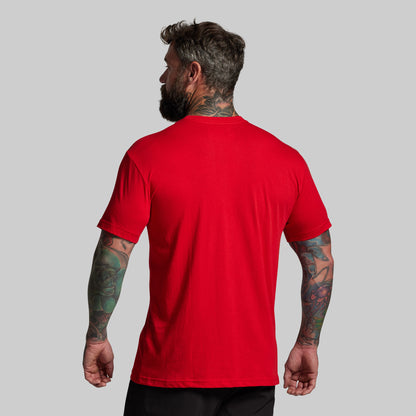 Man wearing a red t-shirt on a gray background