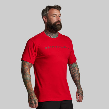 Man wearing a red t-shirt with a logo on a gray background