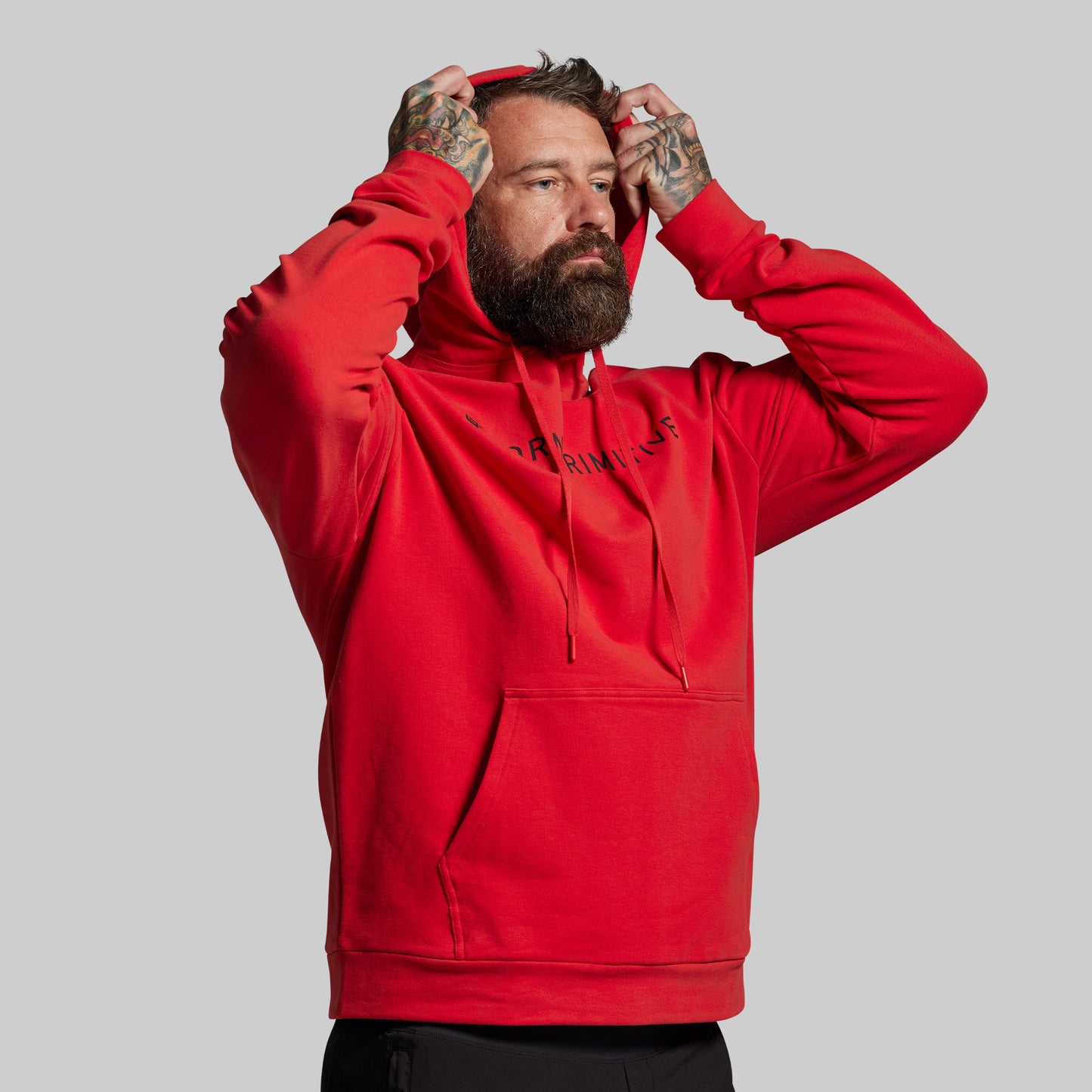 Man wearing a red hoodie with text on a gray background