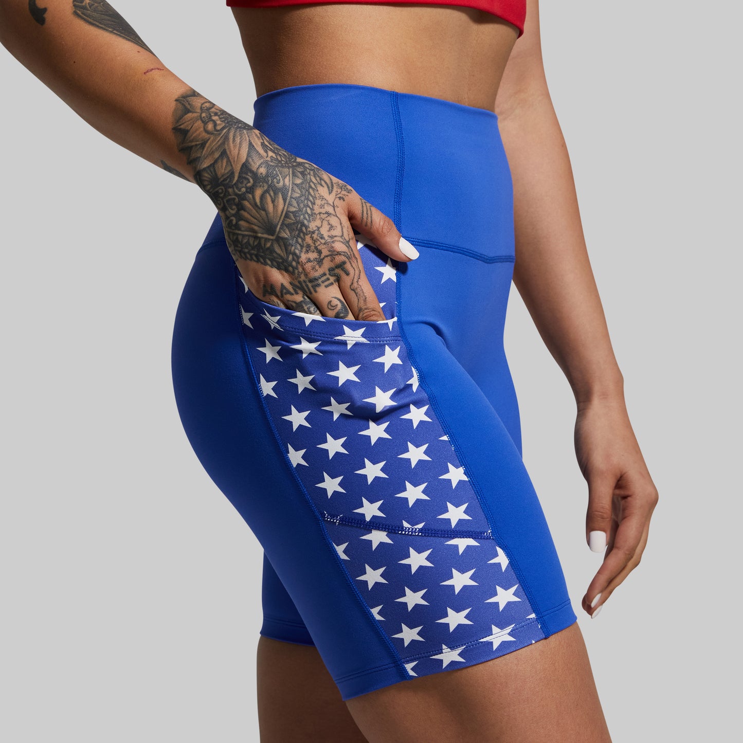 Blue athletic shorts with star pattern on a gray background