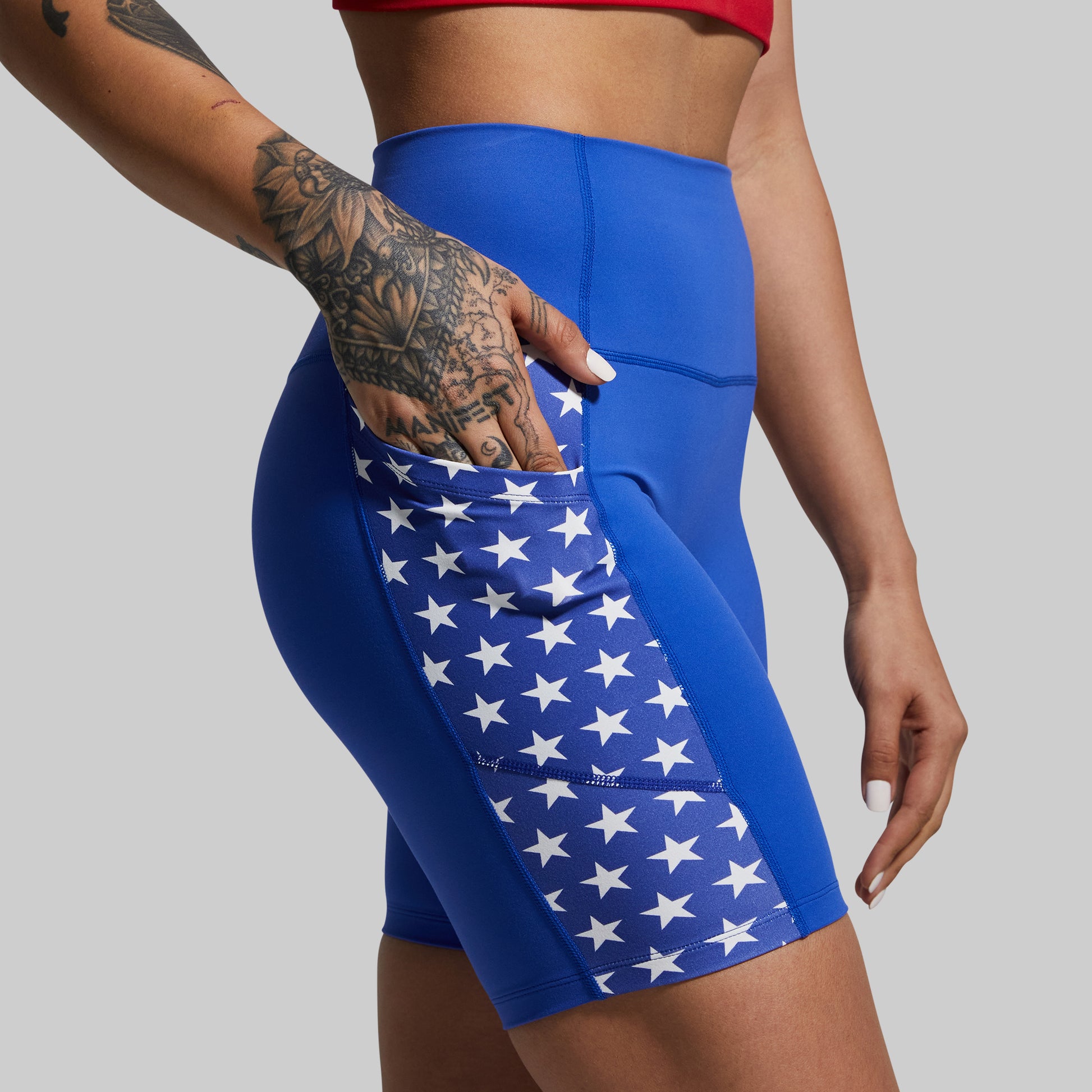 Blue athletic shorts with star pattern on a gray background