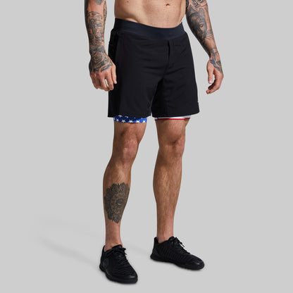 Person wearing black shorts on a gray background