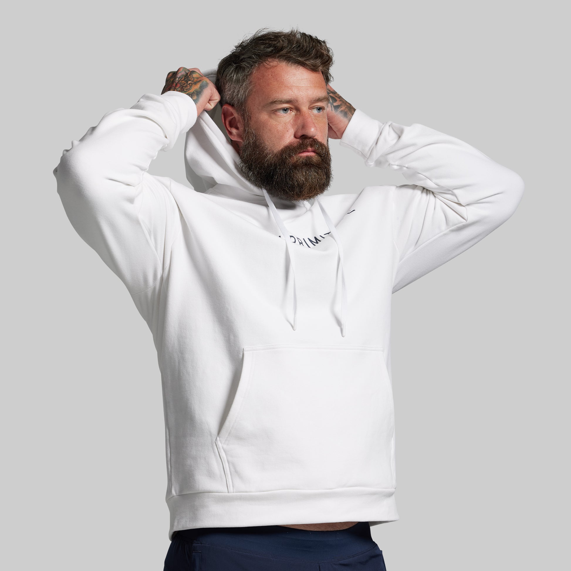 Man wearing a white hoodie with text on a gray background