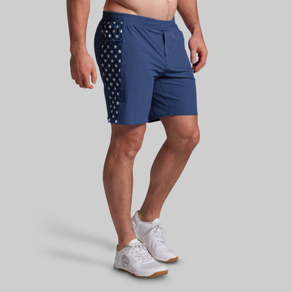 Person wearing blue shorts with American flag design on a gray background