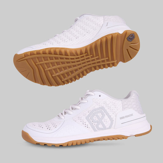 White sneakers with brown soles on a gray background