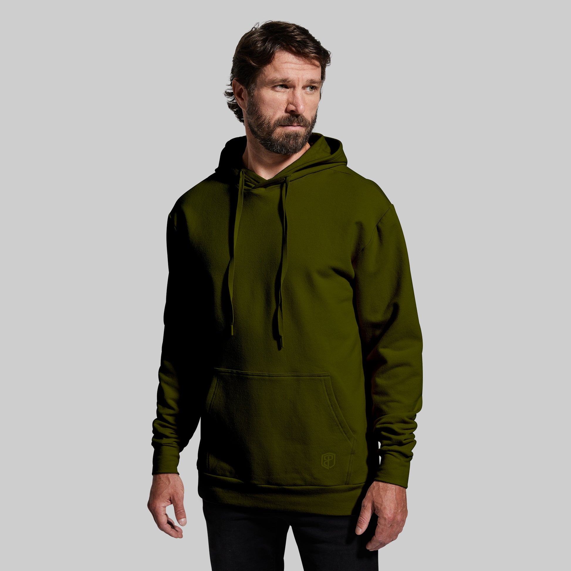 Man wearing a green hoodie against a gray background