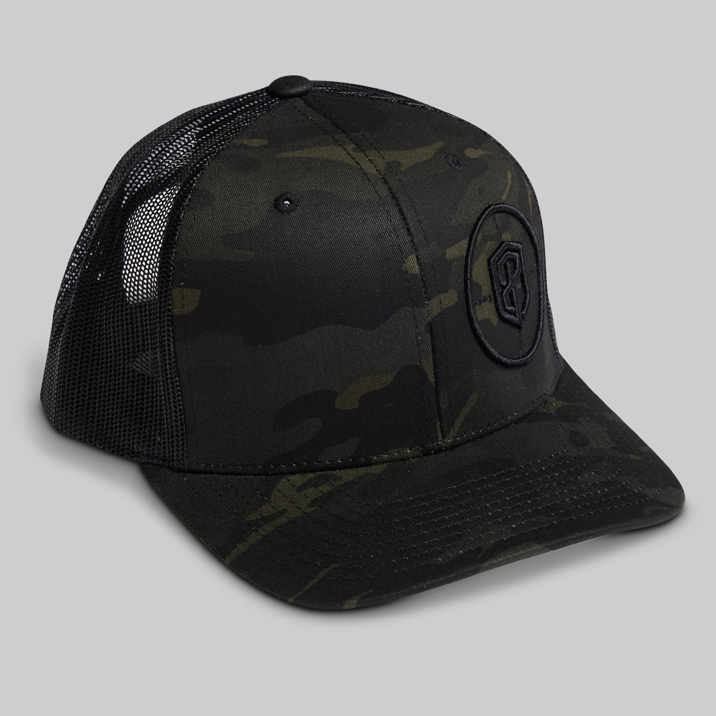 Black camouflage baseball cap with a logo on a gray background
