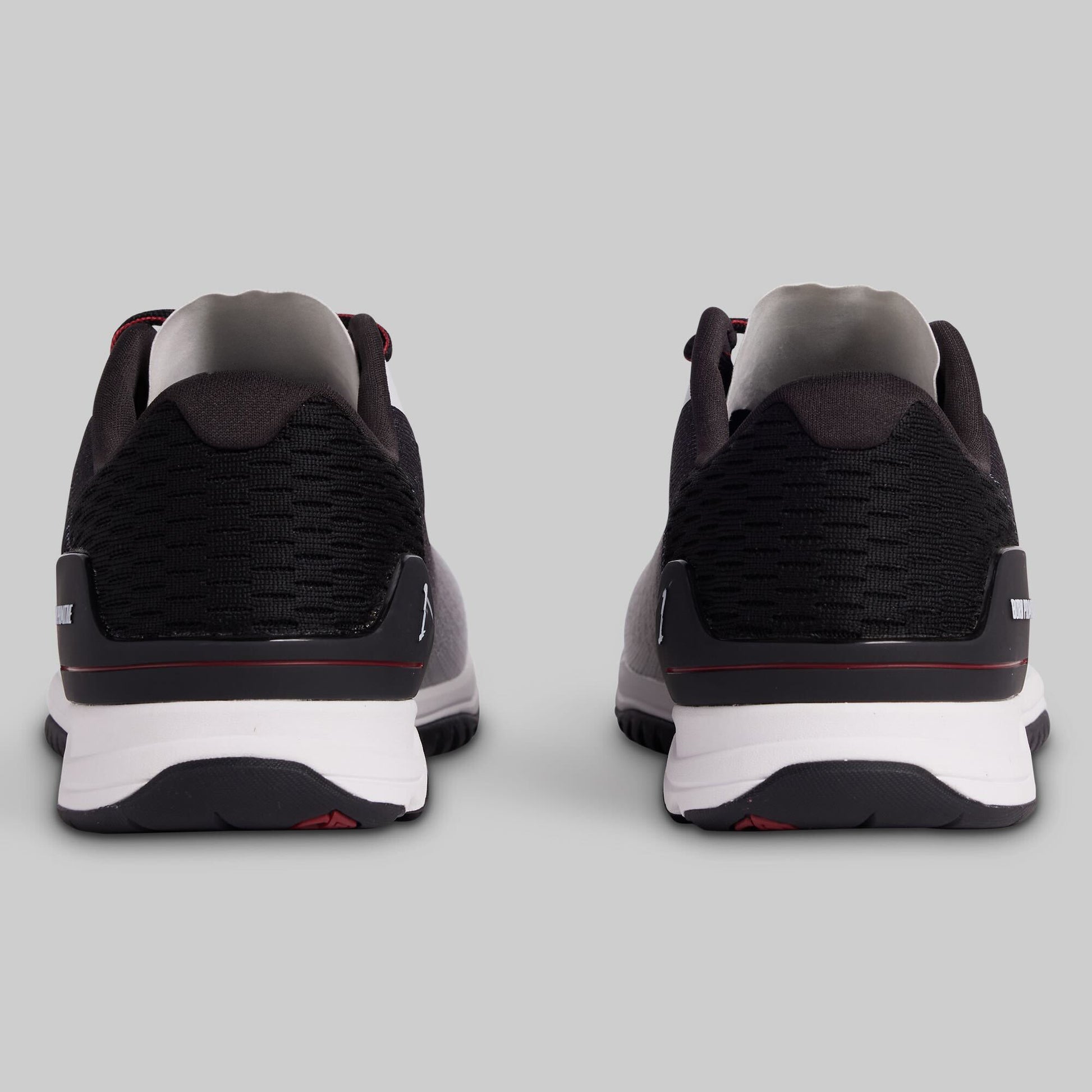 Black and white athletic shoes on a gray background