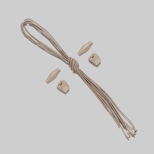 Tan shoelaces, 2 lace keepers, and 2 rubber pull tabs on a plain background.