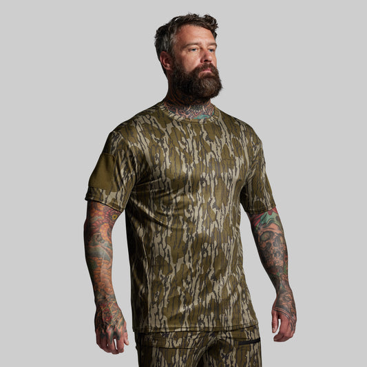Man wearing a camouflage short sleeve on a gray background