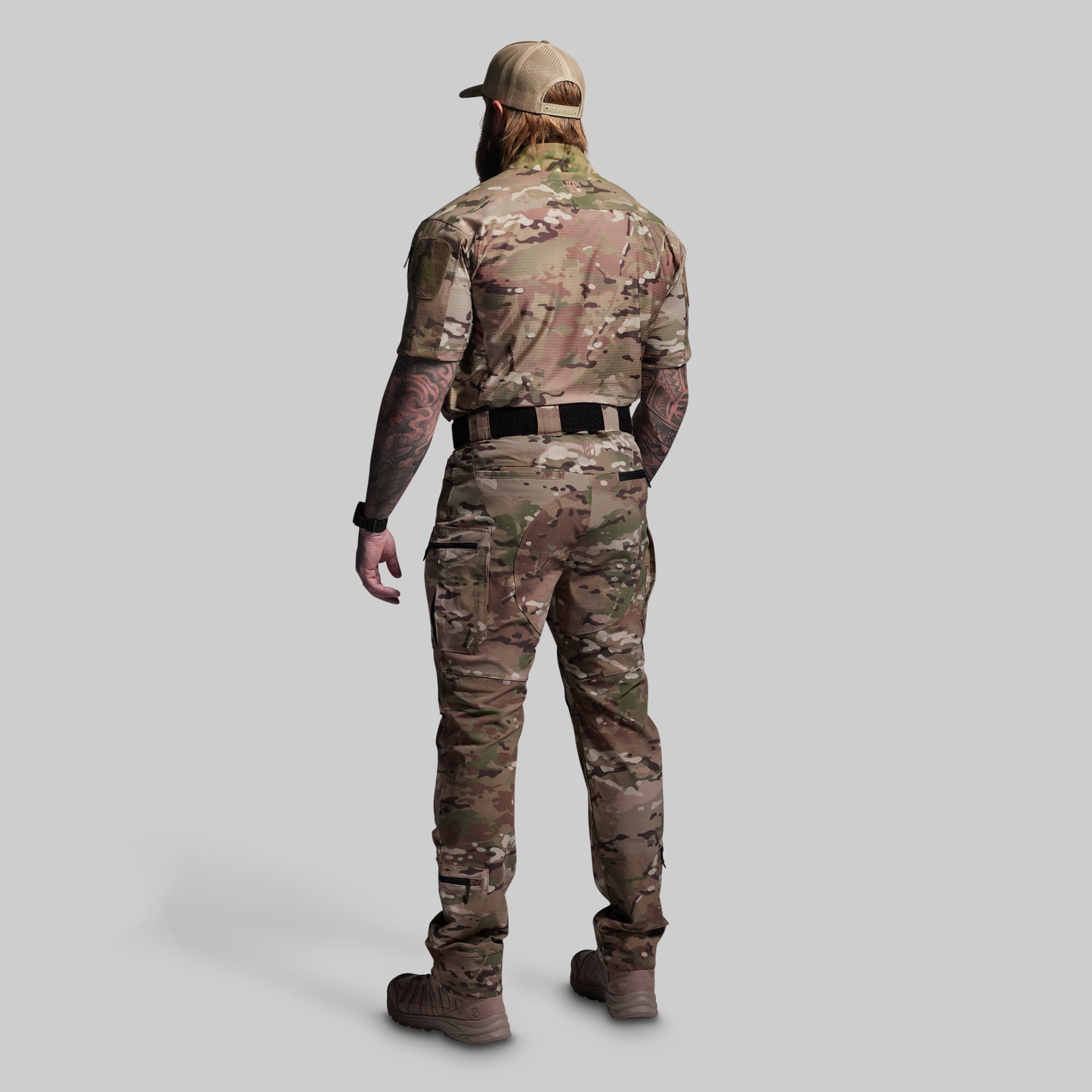 Person wearing a camouflage outfit on a gray background