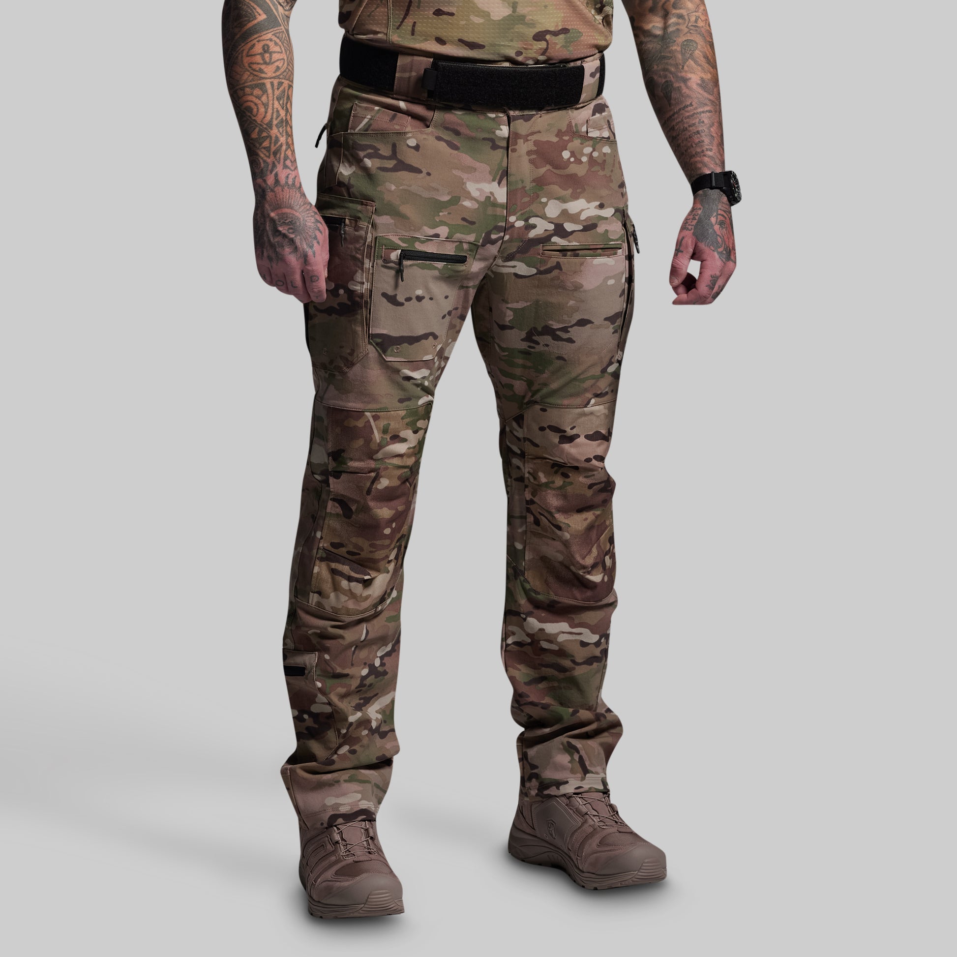 Person wearing camouflage pants on a gray background
