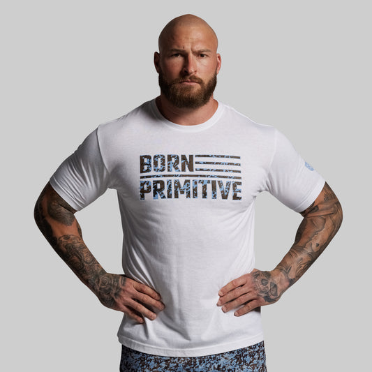 Man wearing a white t-shirt with 'Born Primitive' text on a gray background