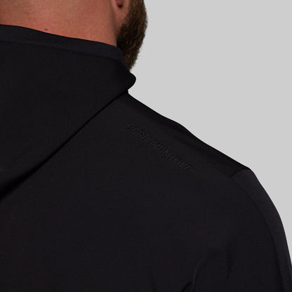 Close-up of a black hoodie with a brand logo on a gray background