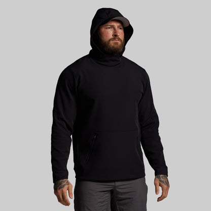 Man wearing a black hoodie on a gray background