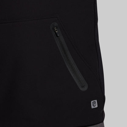 Close-up of a black jacket with a zipper and a brand logo on a light gray background