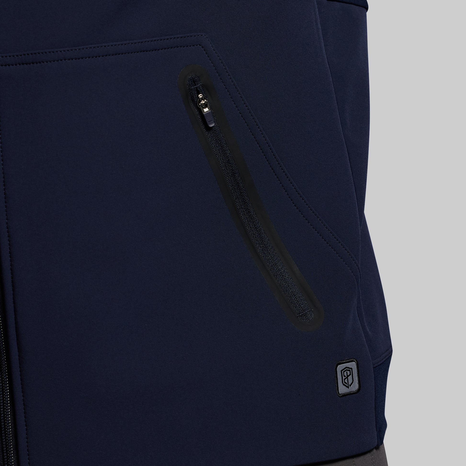 Navy blue hoodie with a zipper pocket on a gray background
