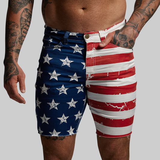 Person wearing shorts with American flag design on a plain background