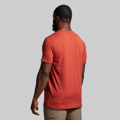 Person wearing a red t-shirt against a gray background