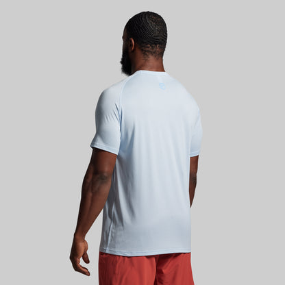 Person wearing a light blue t-shirt and red shorts on a plain background.