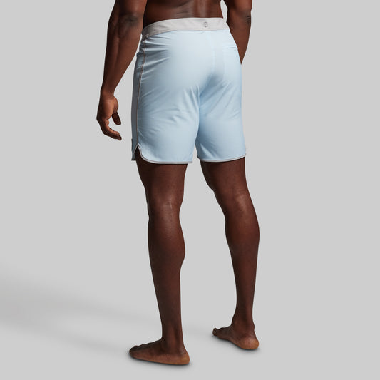 Person wearing light blue shorts on a plain background