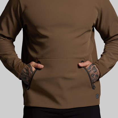 Brown hoodie worn by a person on a gray background