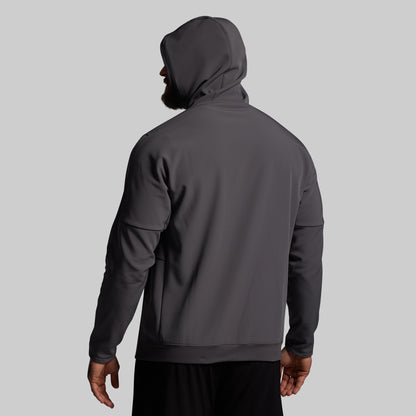 Person wearing a dark gray hoodie on a light gray background