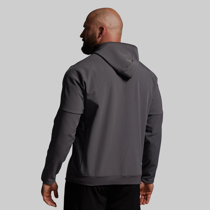 Man wearing a gray hoodie from behind on a light gray background