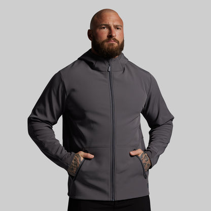 Man wearing a gray hoodie against a plain background