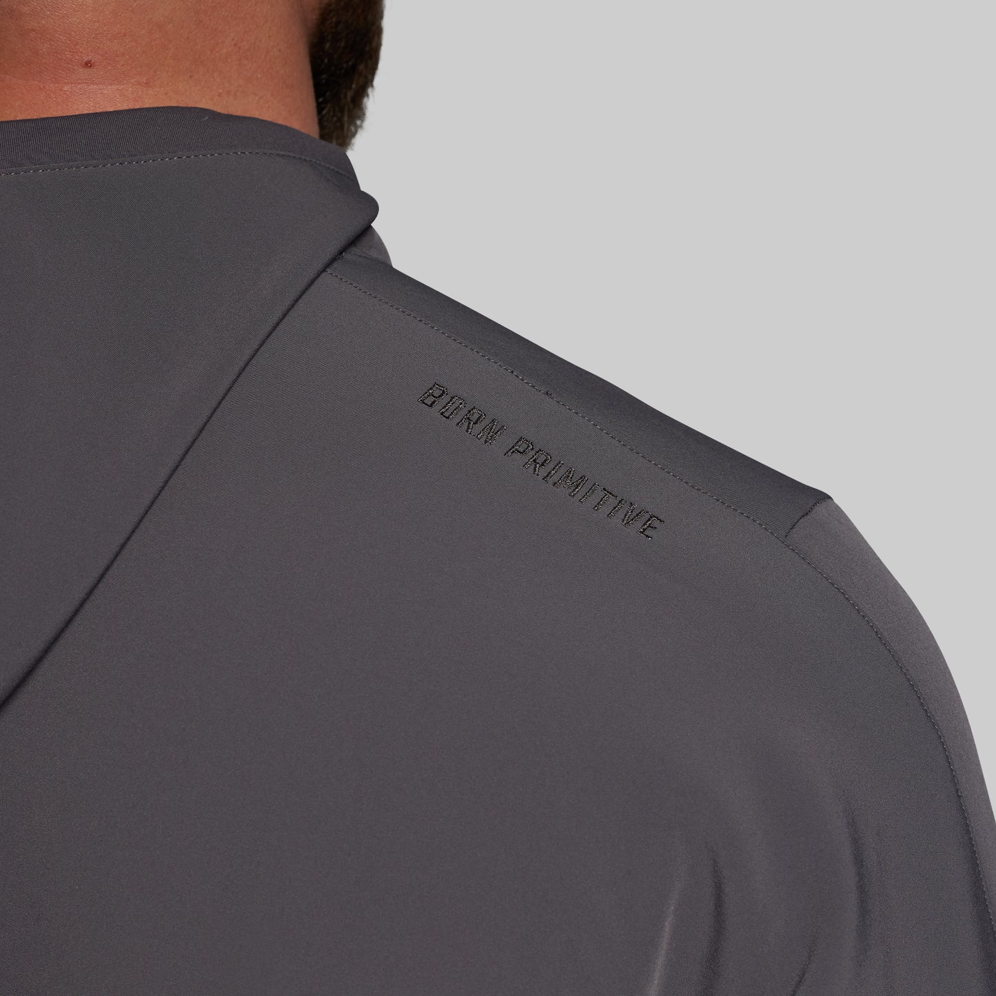 Gray hoodie with 'Born Primitive' branding on a gray background