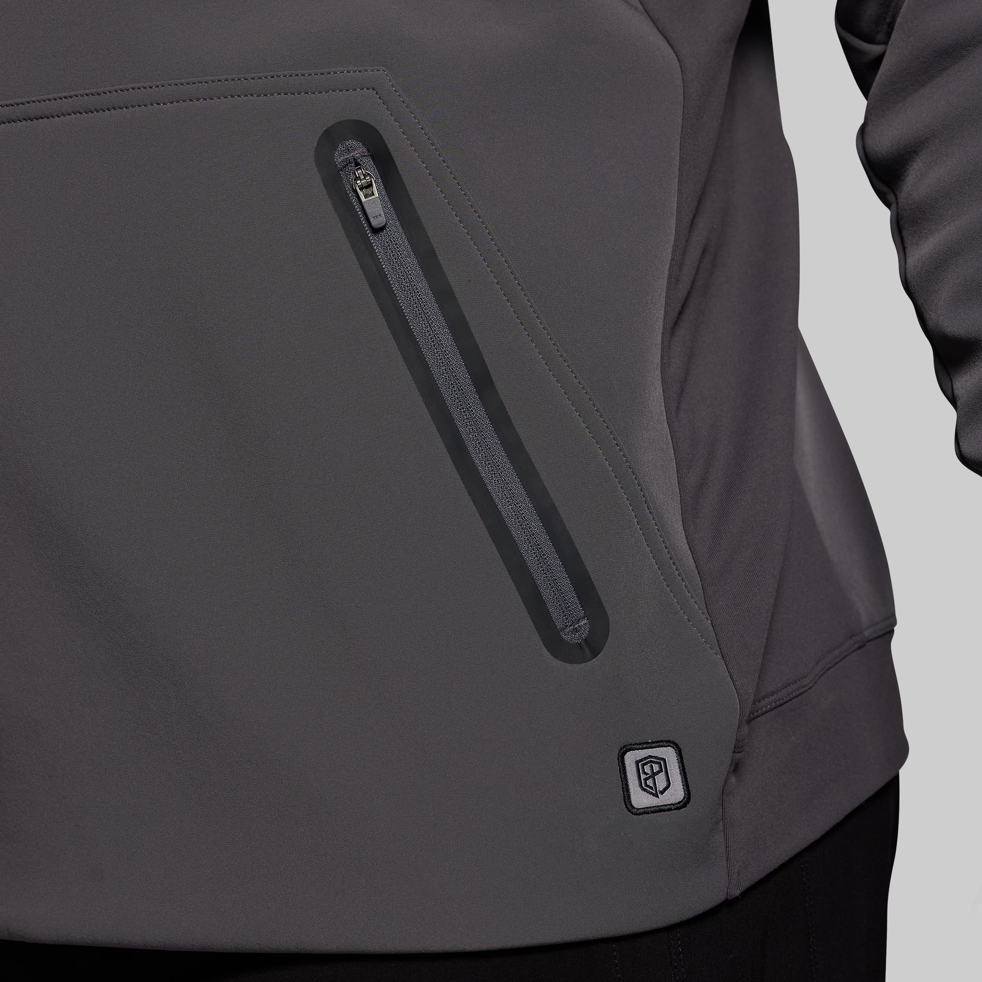 Gray jacket with a zipper pocket on a gray background