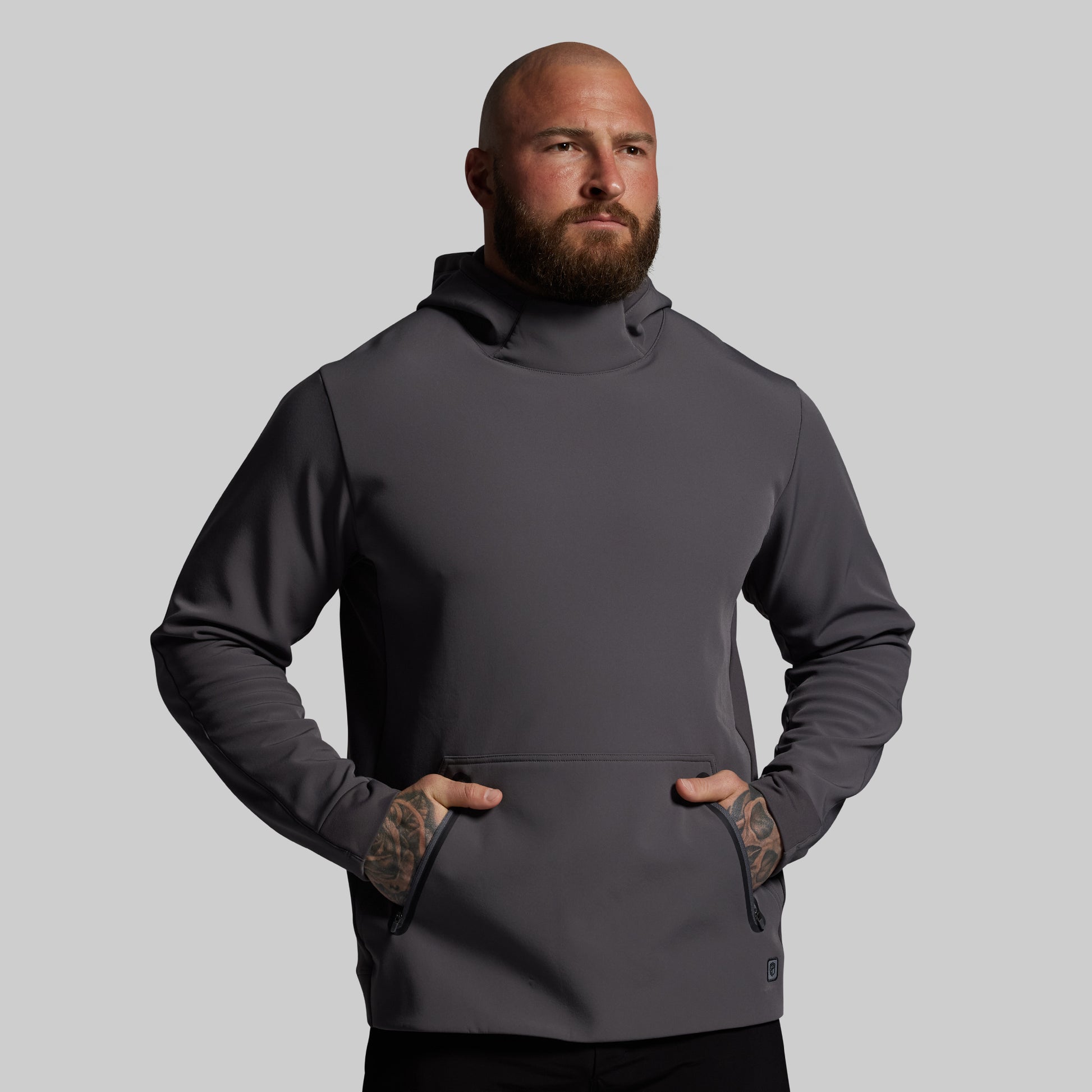 Man wearing a gray hoodie against a plain background