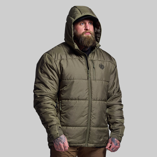 Man wearing a green puffer jacket on a gray background
