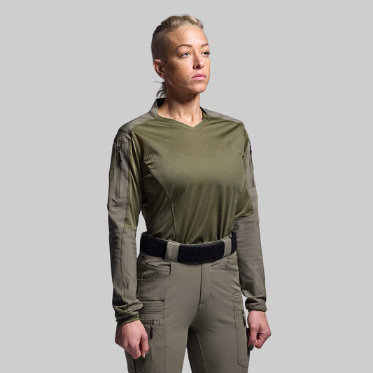 Person wearing a green tactical outfit on a gray background