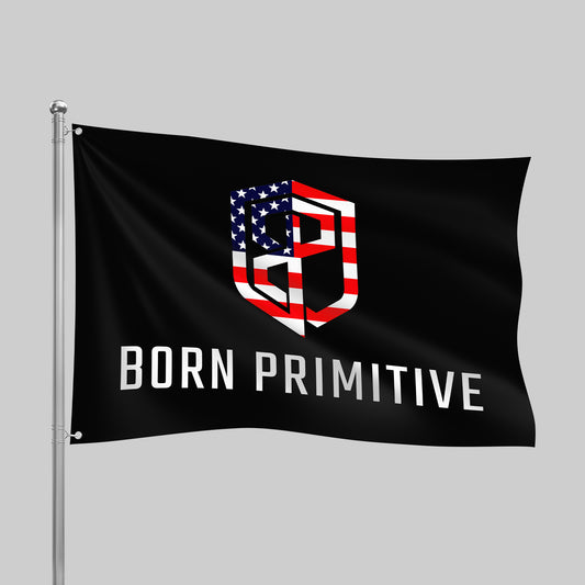 Black flag with 'Born Primitive' logo featuring an American flag design on a gray background