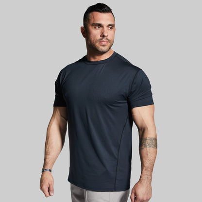 Man wearing a black athletic t-shirt against a gray background